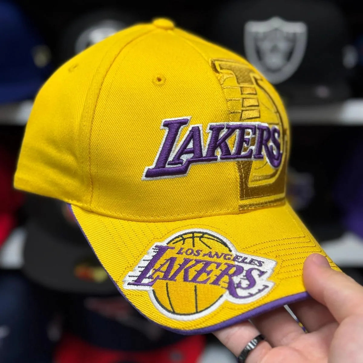 Vintage Lakers Kobe 8 tribute cap in yellow held in the Cap World shop